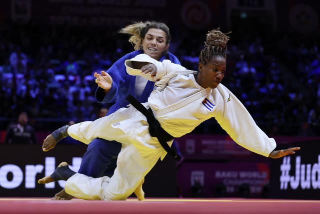 Cuba's Maylin Del Toro Carvajal (white) competes against Turkey's Fidan Ogel in the mixed team round of 16 at the World Judo Championships in Baku on October 11, 2026. (Photo by Anne-Christine POUJOULAT / AFP)