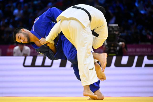 Kazakhstan's Yermakhan Anurbekov (white) competes against France's Aleksa Mitrovic in the mixed team round of 16 at the World Judo Championships in Baku on October 11, 2026. (Photo by Alexander NEMENOV / AFP)