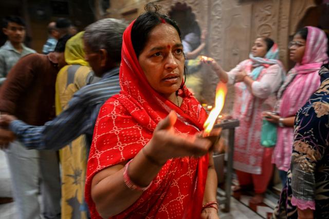 A devotee offers prayers to an idol of Hindu goddess Durga on the first day of the Navratri festival in Amritsar on October 11, 2026. (Photo by Narinder NANU / AFP)