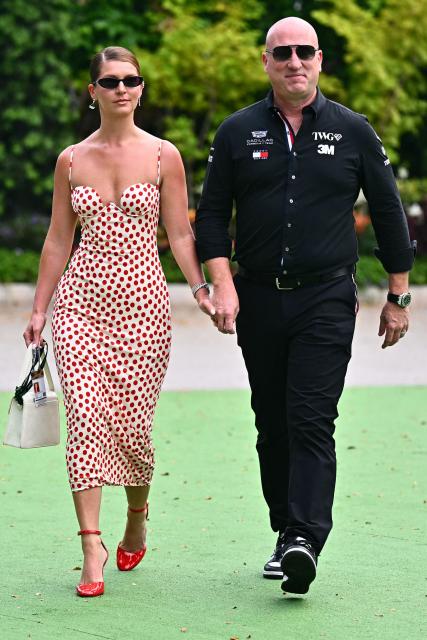 Cadillac F1 CEO Dan Towriss (R) and his wife Cassidy Towriss arrive in the paddock before the start of the Formula One Singapore Grand Prix at the Marina Bay Street Circuit in Singapore on October 11, 2026. (Photo by Lillian SUWANRUMPHA / AFP)