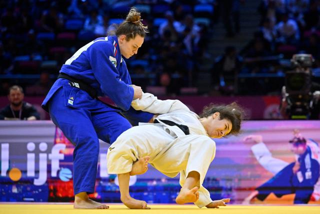 Russia's Madina Taimazova (white) competes against France's Clemence Eme in the mixed team quarter-final at the World Judo Championships in Baku on October 11, 2026. (Photo by Alexander NEMENOV / AFP)