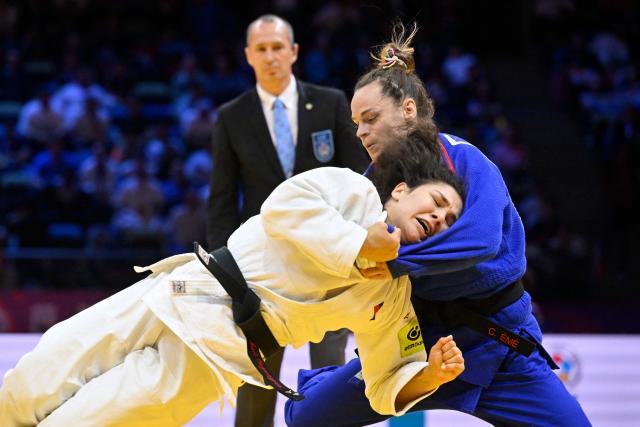 Russia's Madina Taimazova (white) competes against France's Clemence Eme in the mixed team quarter-final at the World Judo Championships in Baku on October 11, 2026. (Photo by Alexander NEMENOV / AFP)