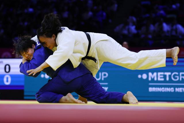 Mongolia's Adiyasuren Amarsaikhan (white) competes against Japan's Mao Arai in the mixed team quarter-final at the World Judo Championships in Baku on October 11, 2026. (Photo by Anne-Christine POUJOULAT / AFP)