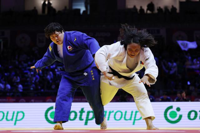 Mongolia's Adiyasuren Amarsaikhan (white) competes against Japan's Mao Arai in the mixed team quarter-final at the World Judo Championships in Baku on October 11, 2026. (Photo by Anne-Christine POUJOULAT / AFP)