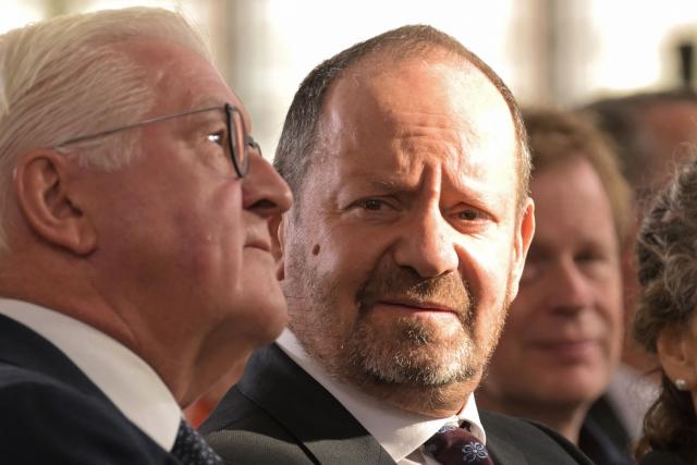 Laureate British-French lawyer and writer Philippe Sands (R) looks on next to German President Frank-Walter Steinmeier during the awarding ceremony for the 2026 Peace Prize of the German Book Trade at the St Paul's Church in Frankfurt am Main, western Germany on October 11, 2026. In its statement, the jury wrote: 'As one of the most important intellectual voices of our time, the French-British lawyer and writer advocates for justice, peace, and the steadfast defense of international law. A descendant of Holocaust survivors, he uses his own family history to show how this body of law came into being and what experiences lie behind the legal concepts of 'genocide' and 'crimes against humanity'.' (Photo by Thomas Lohnes / POOL / AFP)