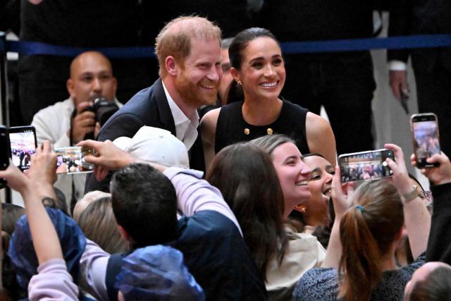 (FILES) Britain's Prince Harry (L), Duke of Sussex, and his wife Meghan (R), the Duchess of Sussex, meet people at the Royal Children's Hospital in Melbourne on April 14, 2026. Britain's Prince Harry and his wife Meghan will on Thursday, October 15, carry out their first joint engagement since returning to live in the UK in August, according to media reports. (Photo by William WEST / AFP)