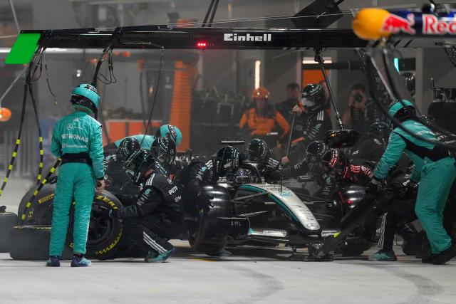 Mechanics work on the car of Mercedes' British driver George Russell during the Formula One Singapore Grand Prix at the Marina Bay Street Circuit in Singapore on October 11, 2026. (Photo by Ng Han Guan / POOL / AFP)