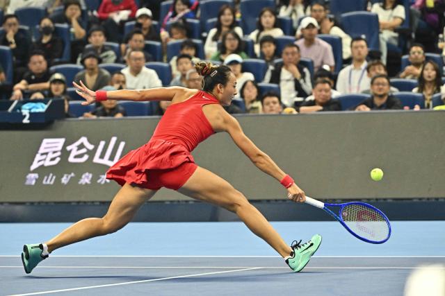China's Zheng Qinwen hits a return to Russia's Mirra Andreeva during their women's singles final at the China Open tennis tournament in Beijing on October 11, 2026. (Photo by Pedro Pardo / AFP)