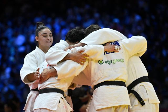 Georgia's team celebrates winning the mixed team bronze medal bout at the World Judo Championships in Baku on October 11, 2026. (Photo by Alexander NEMENOV / AFP)