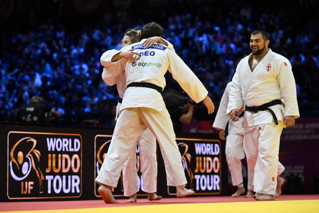Georgia's team celebrates winning the mixed team bronze medal bout at the World Judo Championships in Baku on October 11, 2026. (Photo by Alexander NEMENOV / AFP)