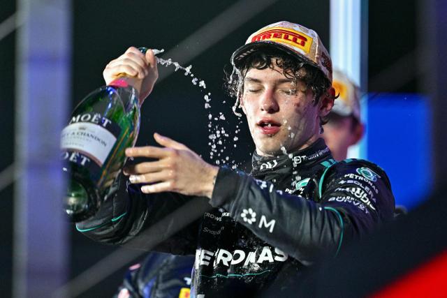 Third-placed Mercedes' Italian driver Kimi Antonelli celebrates on the podium after the Formula One Singapore Grand Prix at the Marina Bay Street Circuit in Singapore on October 11, 2026. (Photo by ANTHONY WALLACE / AFP)