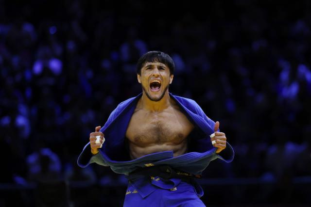 Uzbekistan's Shakhram Ahadov reacts after winning the mixed team bronze medal bout at the World Judo Championships in Baku on October 11, 2026. (Photo by Anne-Christine POUJOULAT / AFP)