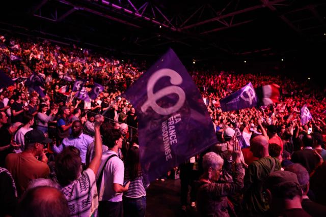 People cheer during a campaign rally of Leftist party La France Insoumise (LFI) ahead of France's 2027 presidential election in Cournon d’Auvergne, central France, on October 11, 2026. (Photo by JEFF PACHOUD / AFP)