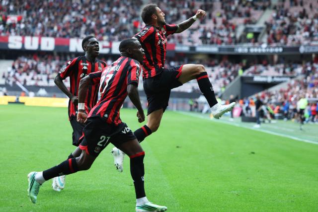 Nice's French defender #92 Jonathan Clauss (R) celebrates after scoring a goal during the French L1 football match between OGC Nice and RC Strasbourg Alsace at the Allianz Riviera Stadium in Nice on October 11, 2026. (Photo by Valery HACHE / AFP)