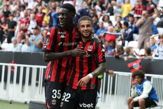 Nice's French defender #92 Jonathan Clauss (R) is congratulated by teammate French defender #35 Xavier Mandza (L) after scoring a goal during the French L1 football match between OGC Nice and RC Strasbourg Alsace at the Allianz Riviera Stadium in Nice on October 11, 2026. (Photo by Valery HACHE / AFP)