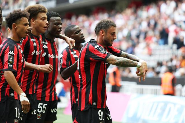 Nice's French defender #92 Jonathan Clauss (R) celebrates with teammates after scoring a goal during the French L1 football match between OGC Nice and RC Strasbourg Alsace at the Allianz Riviera Stadium in Nice on October 11, 2026. (Photo by Valery HACHE / AFP)
