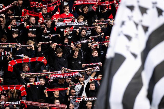 Rennes supporters from the Roazhon Celtic Kop (RCK) wave scarfs as a Brittany flag is waved during the French L1 football match between Stade Rennais FC and AJ Auxerre at the Roazhon Park Stadium in Rennes, western France on October 11, 2026. (Photo by Guillaume SALIGOT / AFP)