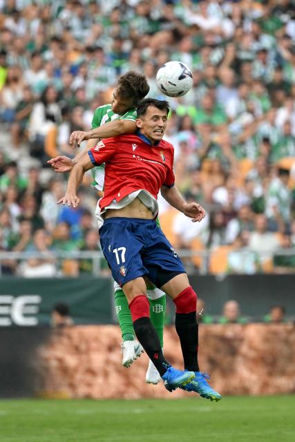 Real Betis' Spanish defender #03 Diego Llorente and Osasuna's Croatian forward #17 Ante Budimir vie for a header during the Spanish league football match between Real Betis and CA Osasuna at Benito Villamarin Stadium in Seville on October 11, 2026. (Photo by JORGE GUERRERO / AFP)