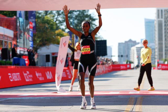 Ethiopian runner Hawi Feysa crosses the finish line to win first place in the women's professional division during the 2026 Chicago Marathon in Chicago, Illinois on October 11, 2026. (Photo by KAMIL KRZACZYNSKI / AFP)