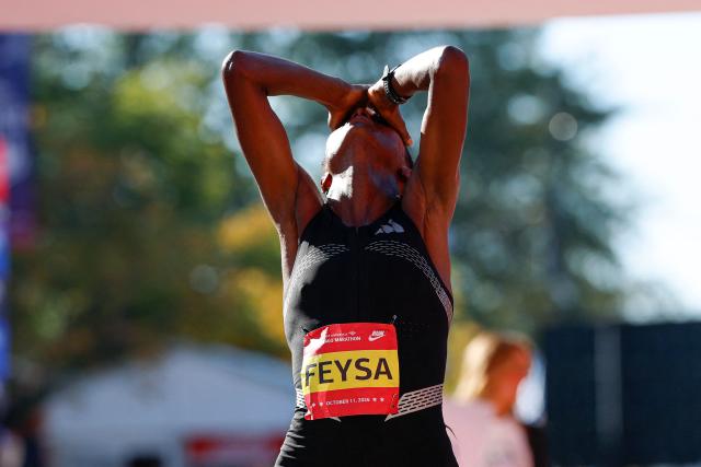 Ethiopian runner Hawi Feysa reacts after crossing the finish line to win first place in the women's professional division during the 2026 Chicago Marathon in Chicago, Illinois on October 11, 2026. (Photo by KAMIL KRZACZYNSKI / AFP)