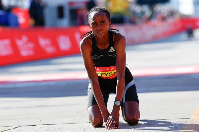 Ethiopian runner Hawi Feysa reacts after crossing the finish line to win first place in the women's professional division during the 2026 Chicago Marathon in Chicago, Illinois on October 11, 2026. (Photo by KAMIL KRZACZYNSKI / AFP)
