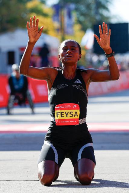 Ethiopian runner Hawi Feysa reacts after crossing the finish line to win first place in the women's professional division during the 2026 Chicago Marathon in Chicago, Illinois on October 11, 2026. (Photo by KAMIL KRZACZYNSKI / AFP)