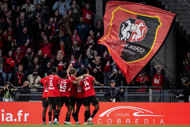 Rennes players celebrate after Rennes' Senegalese forward #22 Boulaye Dia (not pictured) scored his team's fourth goal during the French L1 football match between Stade Rennais FC and AJ Auxerre at the Roazhon Park Stadium in Rennes, western France on October 11, 2026. (Photo by Guillaume SALIGOT / AFP)