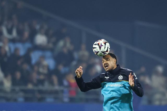 Marseille's English defender #04 CJ Egan-Riley heads the ball as he warms up ahead of the French L1 football match between ES Troyes AC and Olympique de Marseille (OM) at the Stade de l'Aube in Troyes, central France, on October 11, 2026. (Photo by Sameer Al-DOUMY / AFP)