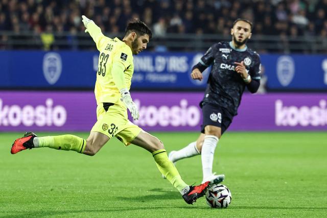 Troyes' Australian goalkeeper #33 Patrick Beach (L) clears the ball during the French L1 football match between ES Troyes AC and Olympique de Marseille (OM) at the Stade de l'Aube in Troyes, central France, on October 11, 2026. (Photo by Sameer Al-DOUMY / AFP)