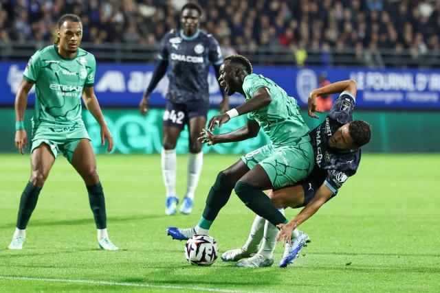Troyes' Senegalese midfielder #08 Mouhamed Diop (2nd R) fights for the ball with Marseille's Moroccan forward #77 Amine Harit (R) during the French L1 football match between ES Troyes AC and Olympique de Marseille (OM) at the Stade de l'Aube in Troyes, central France, on October 11, 2026. (Photo by Sameer Al-DOUMY / AFP)
