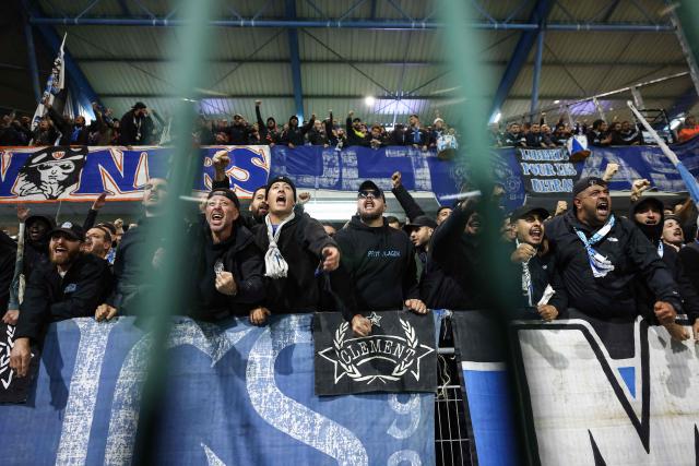 Marseille's supporters cheer their team  during the French L1 football match between ES Troyes AC and Olympique de Marseille (OM) at the Stade de l'Aube in Troyes, central France, on October 11, 2026. (Photo by Sameer Al-DOUMY / AFP)