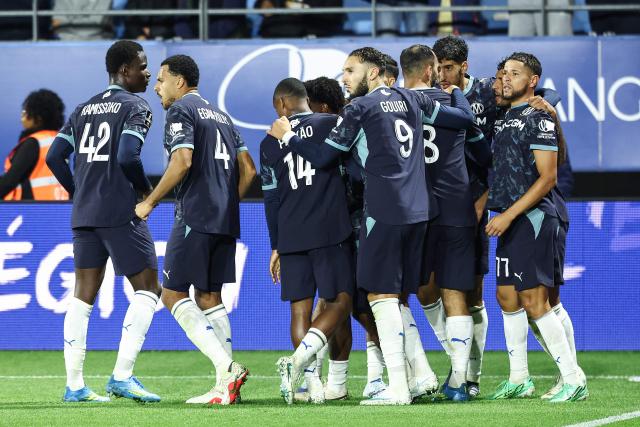 Marseille's Moroccan forward #77 Amine Harit (R) celebrates with team mates after scoring a goal during the French L1 football match between ES Troyes AC and Olympique de Marseille (OM) at the Stade de l'Aube in Troyes, central France, on October 11, 2026. (Photo by Sameer Al-DOUMY / AFP)