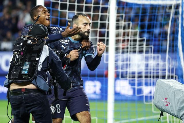 Marseille's Algerian midfielder #08 Himad Abdelli (R) celebrates scoring his team's second goal during the French L1 football match between ES Troyes AC and Olympique de Marseille (OM) at the Stade de l'Aube in Troyes, central France, on October 11, 2026. (Photo by Sameer Al-DOUMY / AFP)