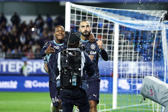Marseille's Algerian midfielder #08 Himad Abdelli (R) celebrates scoring his team's second goal during the French L1 football match between ES Troyes AC and Olympique de Marseille (OM) at the Stade de l'Aube in Troyes, central France, on October 11, 2026. (Photo by Sameer Al-DOUMY / AFP)