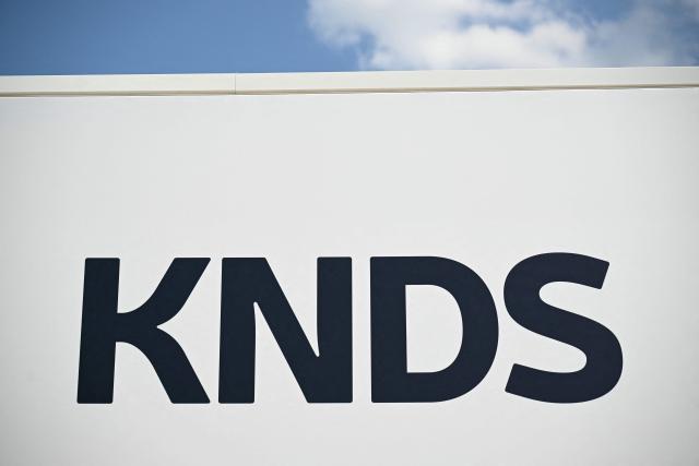 (FILES) This photograph shows the logo of French-German defence group KNDS at the Paris International Air Show (Salon international de l'aeronautique et de l'espace - SIAE) at the Paris–Le Bourget Airport, north of Paris, on June 17, 2025. French defence group KNDS will go on trial in Bourges, central France on October 14, 2026, over a 2023 workplace accident that killed one employee and seriously injured another. (Photo by Bertrand GUAY / AFP)