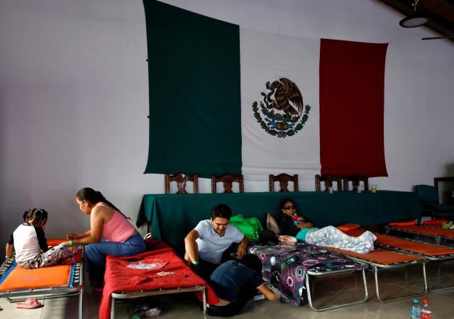 Members of a family who voluntarily evacuated their home due to the risk of flooding take shelter ahead of the expected impact of Hurricane Simon at a municipal DIF facility in Puerto Vallarta, Jalisco state, Mexico, on October 11, 2026. Hurricane Simon strengthened into a powerful Category 4 storm and was expected to make landfall or skirt the coast of west-central Mexico on October 11, 2026, according to the US National Hurricane Center. (Photo by ULISES RUIZ / AFP)