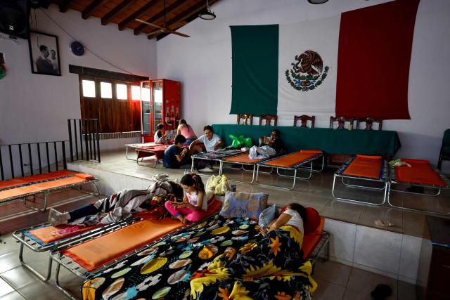 Members of a family who voluntarily evacuated their home due to the risk of flooding take shelter ahead of the expected impact of Hurricane Simon at a municipal DIF facility in Puerto Vallarta, Jalisco state, Mexico, on October 11, 2026. Hurricane Simon strengthened into a powerful Category 4 storm and was expected to make landfall or skirt the coast of west-central Mexico on October 11, 2026, according to the US National Hurricane Center. (Photo by ULISES RUIZ / AFP)