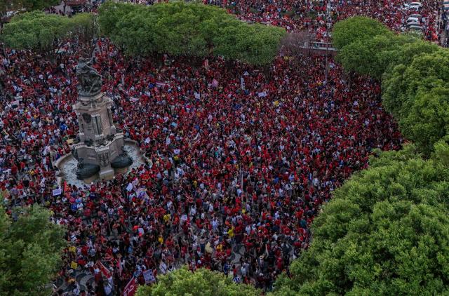 This aerial view shows supporters of Brazilian President and presidential candidate Luiz Inácio Lula da Silva of the Workers' Party (PT) attending a rally in downtown Manaus, in the state of Amazonas, northern Brazil, on October 11, 2026, ahead of the presidential runoff election. (Photo by MICHAEL DANTAS / AFP)