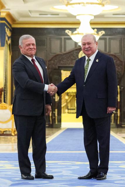 Jordan's King Abdullah II (L) and Malaysia's King Sultan Ibrahim Sultan Iskandar shake hands at the National Palace in Kuala Lumpur on October 12, 2026. (Photo by Hasnoor Hussain / POOL / AFP)