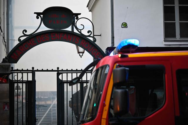This photograph shows one of the entrances of «Le marche des Enfants Rouges» (Red Children market) as firefighters work to extinguish a fire, center of Paris on October 12, 2026. (Photo by JULIEN DE ROSA / AFP)