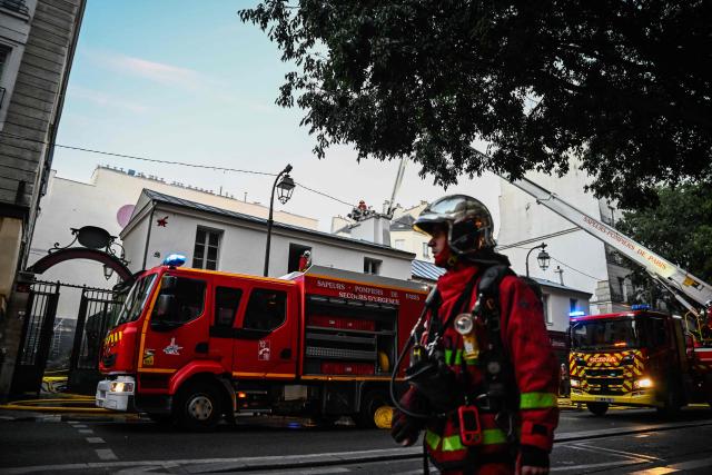 Firefighters work to extinguish a fire at «Le marche des Enfants Rouges» (Red Children market) center of Paris on October 12, 2026. (Photo by JULIEN DE ROSA / AFP)