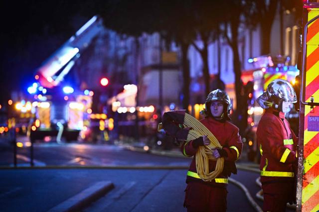 Firefighters work to extinguish a fire at «Le marche des Enfants Rouges» (Red Children market) center of Paris on October 12, 2026. (Photo by JULIEN DE ROSA / AFP)