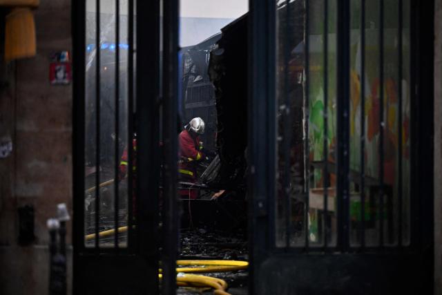 Firefighters work to extinguish a fire at «Le marche des Enfants Rouges» (Red Children market) center of Paris on October 12, 2026. (Photo by JULIEN DE ROSA / AFP)