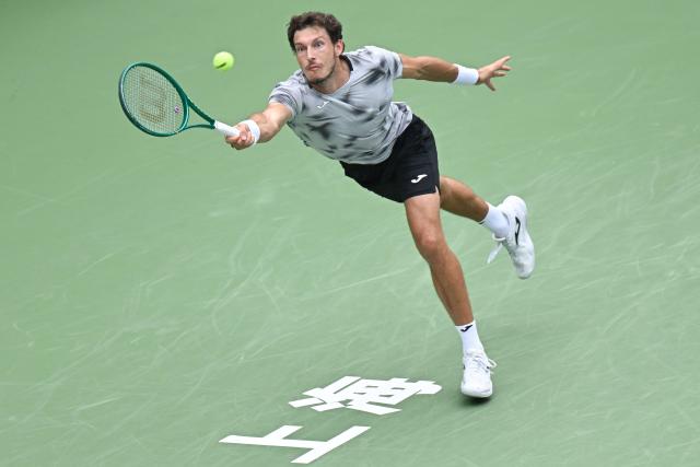 Spain’s Pablo Carreno Busta hits a return to Canada’s Felix Auger-Aliassime during their men's singles match at the Shanghai Masters tennis tournament in Shanghai on October 12, 2026. (Photo by CN-STR / AFP) / China OUT
