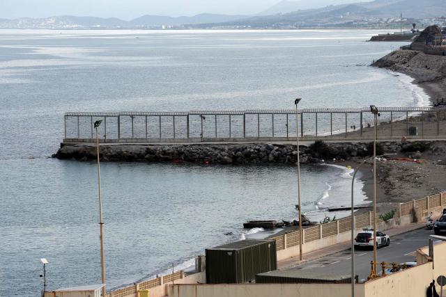 The anti-migration barrier on the seawall border separating Morocco from Spain's North African enclave of Ceuta is pictured on 11 October, 2026. Spain's King Felipe VI and Queen Letizia are scheduled to visit Ceuta on October 13, 2026. The Spanish North African enclave of some 80,000 inhabitants seek to regain balance while hundreds of migrants remain in makeshifts camp after the massive influx of tens of thousands of migrants from Morocco in late July. (Photo by Thomas COEX / AFP)