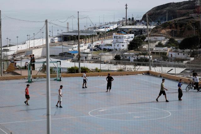People living in the Principe Felipe neighbourhood play football in the Spain's North African enclave of Ceuta on 11 October, 2026. Spain's King Felipe VI and Queen Letizia are scheduled to visit Ceuta on October 13, 2026. The Spanish North African enclave of some 80,000 inhabitants seek to regain balance while hundreds of migrants remain in makeshifts camp after the massive influx of tens of thousands of migrants from Morocco in late July. (Photo by Thomas COEX / AFP)