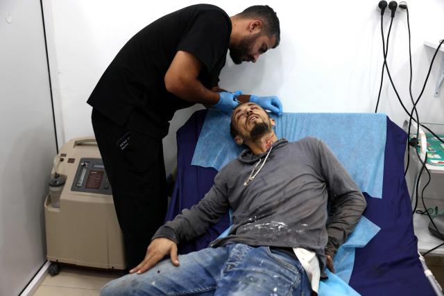 A Palestinian farmer receives medical treatment after reportedly being beaten by an Israeli settler as he harvested his olive grove near the village of Turmus Ayya, north of the city of Ramallah, in the Israeli-occupied West Bank on October 12, 2026. The olive harvest starts in the West Bank in October and makes up a large component of the agricultural economy and cultural life for most Palestinians. Violence has flared in recent months in the West Bank with near-daily attacks, thefts or vandalism by Israeli settlers against Palestinians. Extremist Israeli settlers have been seizing olive groves owned by Palestinians, who see the trees as a cultural symbol. Some 500,000 Israeli settlers live in the West Bank, which Israel captured in 1967, among three million Palestinians. Settlements in occupied territory are illegal under international law.
 The olive harvest is a major component of the West Banks agricultural economy, rural livelihoods and cultural life. The Ministry of Agriculture estimates that around 750,000 dunums are planted with olive trees in the West Bank.  Olive trees make up about 45% to 48% of all agricultural land in the West Bank and Gaza, and account for roughly 70% of fruit production. (Photo by Zain JAAFAR / AFP)