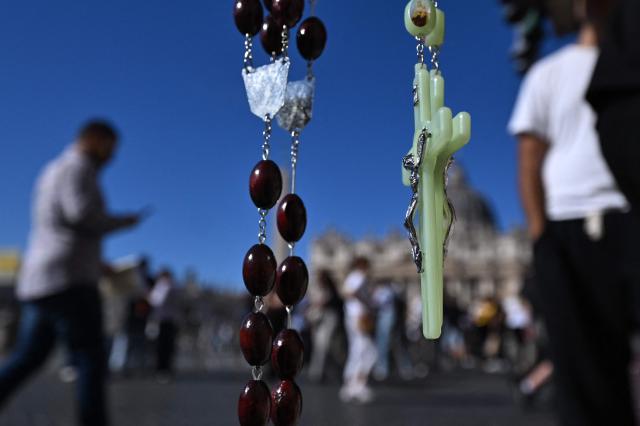 Rosaries are on sale at a souvenirs shop near St Peter's square in the Vatican on October 12, 2026. Pope Leo XIV has said on October 11, 2026 he will have an operation to remove a lump on his lung this week, the first time a pope has made a personal medical announcement of this kind. (Photo by Tiziana FABI / AFP)