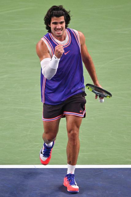 Spain's Carlos Alcaraz celebrates a point against Belgium's Zizou Bergs during their men's singles match at the Shanghai Masters tennis tournament in Shanghai on October 12, 2026. (Photo by Hector RETAMAL / AFP)