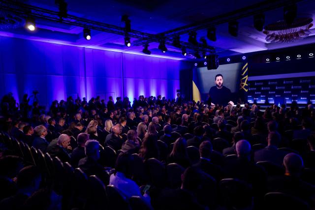Participants listen as Ukraine's President Volodymyr Zelensky speaks via videolink during the opening session of the Warsaw Security Forum in Warsaw, Poland on October 12, 2026. (Photo by Wojtek RADWANSKI / AFP)